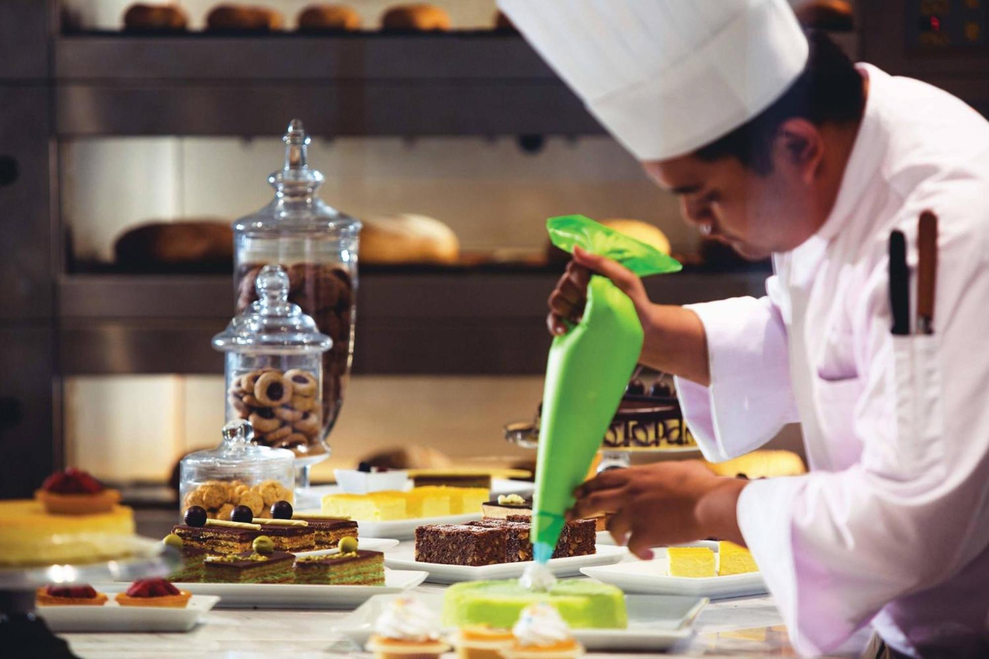 Renaissance Johor Bahru Hotel Exterior photo A pastry chef icing a dessert